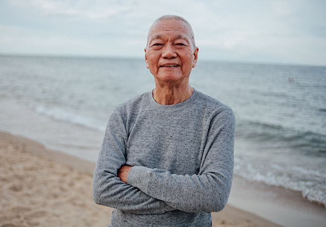 Older man standing on beach